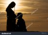 stock-photo-husband-kissing-his-pregnant-wife-silhouette-couple-at-sunset-376079026.jpg