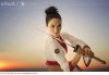 mixed_race_woman_performing_martial_arts_with_sword_BLD077265.jpg